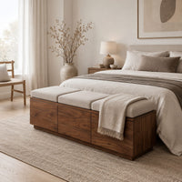 Low wooden bench with three seat cushions and a three panel front in a Scandinavian bedroom with white walls