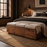 Low wooden bench with three seat cushions and a three panel front in an industrial loft bedroom with exposed brick