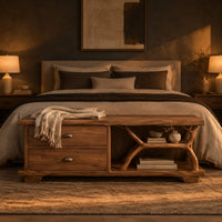 Storage bench with two drawers and a branch shaped open shelf in a dark bedroom at golden hour