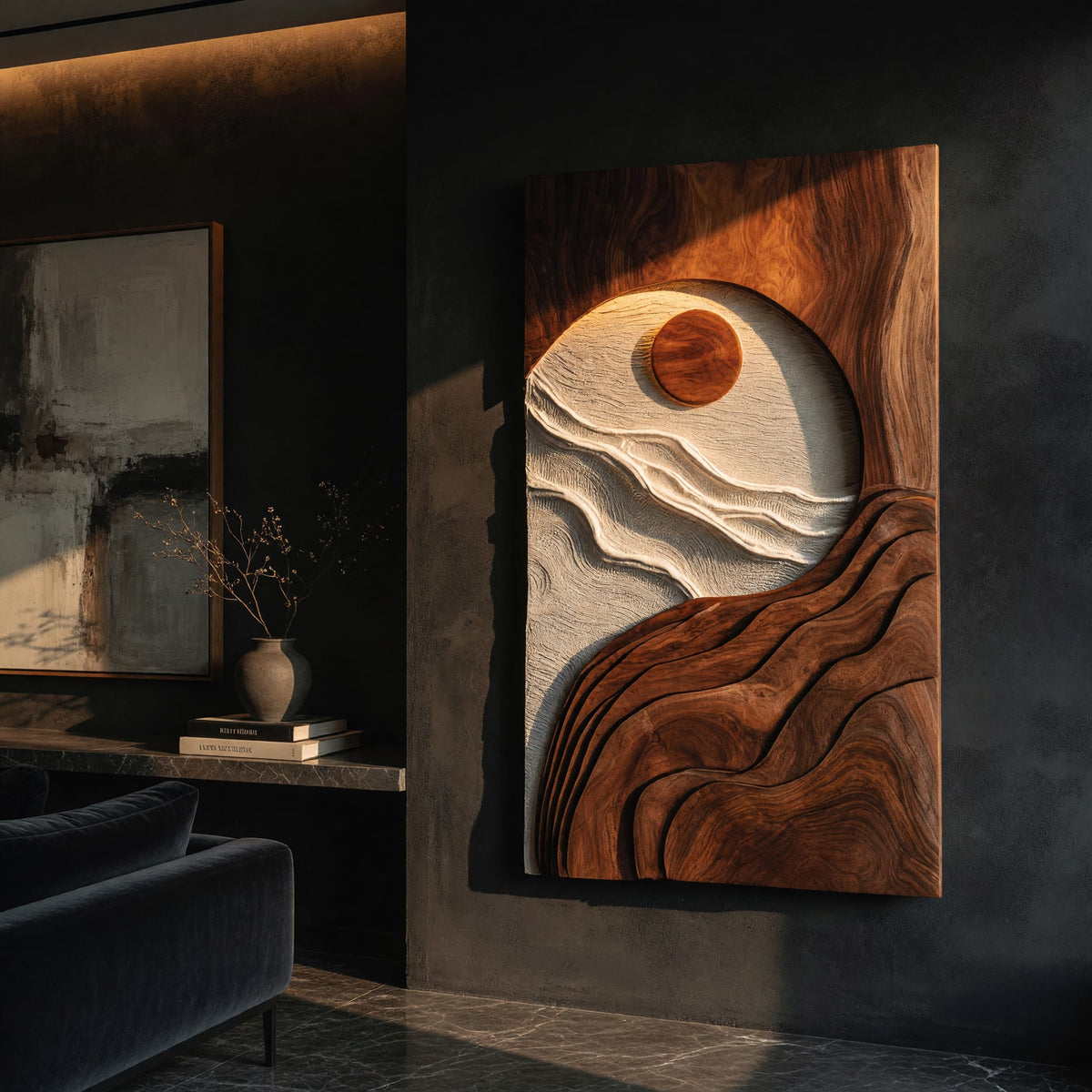 Sun and tide wall panel in pale and dark carved tones on a dark charcoal plaster wall