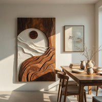 Sun and tide wall panel in pale and dark carved tones beside a dining table in natural light