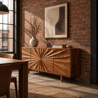 Sideboard with a sunburst carved center panel and short legs in an industrial loft dining room with exposed brick