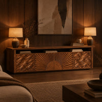 Tv stand with a carved sunburst center and wave relief side panels in an evening living room with walnut wall paneling