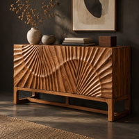 Corner detail of sideboard with sunburst carving across the front on a slim open frame base beside wood, brass and linen samples