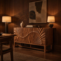 Sideboard with sunburst carving across the front on a slim open frame base in an evening dining room with walnut wall paneling