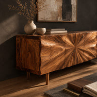 Corner detail of wood sideboard with a sunburst grain pattern and tapered legs beside wood, brass and linen samples