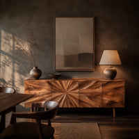 Wood sideboard with a sunburst grain pattern and tapered legs in a dark dining room at golden hour