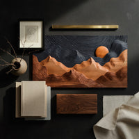Detail of sunrise mountain wall sculpture with a dark carved sky beside wood, brass and linen samples