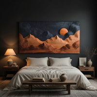 Sunrise mountain wall sculpture with a dark carved sky above a bed in a dusk lit bedroom