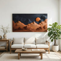Sunrise mountain wall sculpture with a dark carved sky in a bright sunroom with green plants
