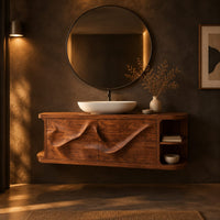 Floating vanity with two sweeping carved doors and curved open end shelves in a dark bathroom at golden hour