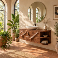 Floating vanity with two sweeping carved doors and curved open end shelves in a bright bathroom with arched windows and plants