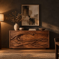 Three door sideboard carved with one long curling wave in a dark dining room at golden hour