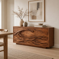 Three door sideboard carved with one long curling wave in a Scandinavian dining room with white walls