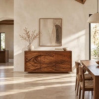 Three door sideboard carved with one long curling wave in a bright open plan dining room