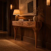 Console table with two front panels and sweeping tapered legs in an evening entryway with walnut wall paneling