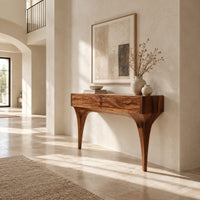 Console table with two front panels and sweeping tapered legs in a bright open plan entryway