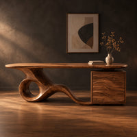 Long desk with a swooping loop base and a wave carved cabinet in a dark studio against a charcoal plaster wall