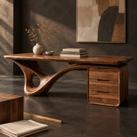 Corner detail of desk with a looping sculpted leg and a three drawer pedestal beside wood, brass and linen samples
