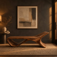 Low sweeping bench with an open loop underside and a raised end in a dark entryway at golden hour