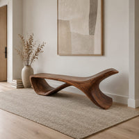 Low sweeping bench with an open loop underside and a raised end in a Scandinavian entryway with white walls
