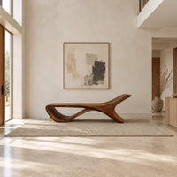 Low sweeping bench with an open loop underside and a raised end in a bright open plan entryway