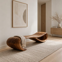 Long wooden bench shaped like a ribbon with a rolled end in a Scandinavian entryway with white walls