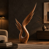 Wood sculpture of a swept wing with carved feather grooves and an open loop in a dark living room at golden hour