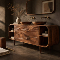 Corner detail of bathroom vanity cabinet with swirl carved doors, open end shelves and slim legs beside wood, brass and linen samples