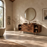 Bathroom vanity cabinet with swirl carved doors, open end shelves and slim legs in a bright open plan bathroom