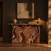Console table with a swirl carved front and a thick natural edge top in a dark entryway at golden hour