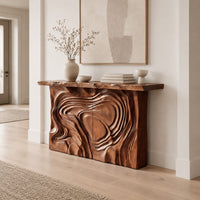 Console table with a swirl carved front and a thick natural edge top in a Scandinavian entryway with white walls