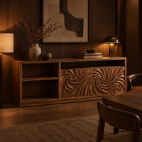 Sideboard with two swirl carved doors and open shelf bays at one end in an evening dining room with walnut wall paneling