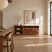 Sideboard with two swirl carved doors and open shelf bays at one end in a bright open plan dining room