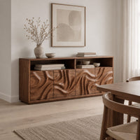 Wood sideboard with swirl carved front panels and two open shelves along the top in a Scandinavian dining room with white walls
