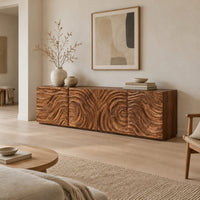 Low wooden tv stand with swirl carved front panels in a Scandinavian living room with white walls