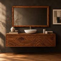 Wall mounted bathroom vanity cabinet with three swirl carved front panels in a dark studio against a charcoal plaster wall