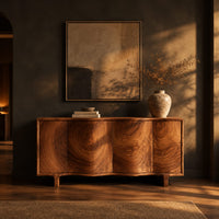 Wavy front sideboard with four panels of swirling wood grain in a dark dining room at golden hour