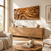 Wide wall art panel carved with deep swirls and eddies that flow like water above a light oak sideboard in daylight