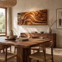 Wide wall art panel carved with deep swirls and eddies that flow like water beside a dining table in natural light