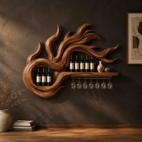 Wine rack carved as swirling flames with a long shelf and stemware rail in a dark studio against a charcoal plaster wall