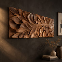 Wide wooden relief panel carved with swirling overlapping leaves on a dark charcoal plaster wall