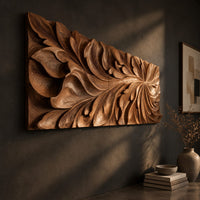 Wide wooden relief panel carved with swirling overlapping leaves, three-quarter view showing the carved depth