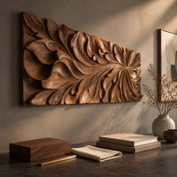 Detail of wide wooden relief panel carved with swirling overlapping leaves beside wood, brass and linen samples