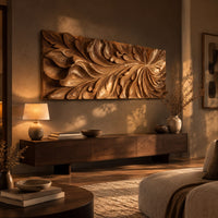 Wide wooden relief panel carved with swirling overlapping leaves above a low console in an evening living room