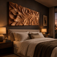 Wide wooden relief panel carved with swirling overlapping leaves above a bed in a dusk lit bedroom