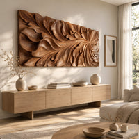 Wide wooden relief panel carved with swirling overlapping leaves above a light oak sideboard in daylight