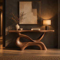 Console table with a slim plank top on a swirling sculpted base in a dark entryway at golden hour