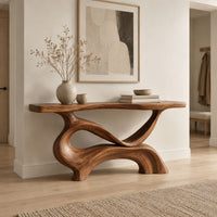 Console table with a slim plank top on a swirling sculpted base in a Scandinavian entryway with white walls