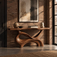 Console table with a slim plank top on a swirling sculpted base in an industrial loft entryway with exposed brick